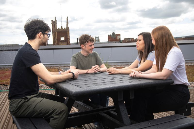 students sitting together outside